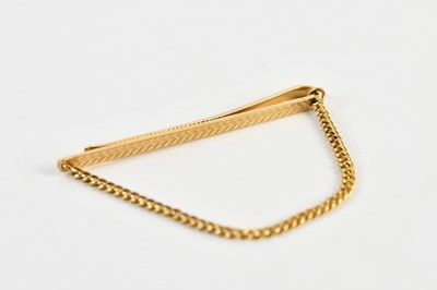 Lot 1250 - A 9ct yellow gold tie clip, with yellow metal...