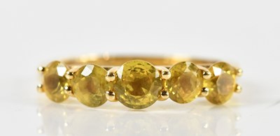 Lot 1423 - An 18ct yellow gold Sri Lankan yellow sapphire...