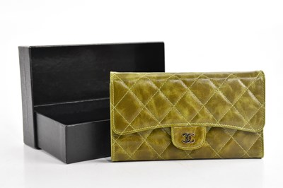 Lot 1904 - CHANEL; a green distressed leather quilted...