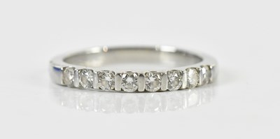 Lot 1400 - A platinum and diamond half eternity ring, set...