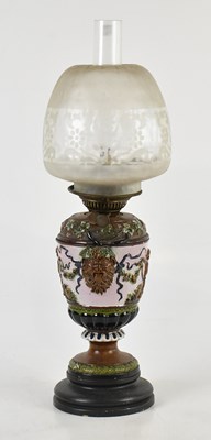 Lot 1567 - A Continental art pottery oil lamp in the...