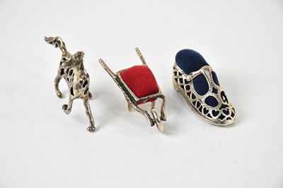 Lot 56 - Three novelty pin cushions comprising a horse...