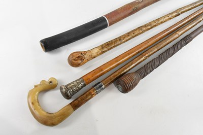 Lot 2554 - A group of three walking sticks, a crook and a...
