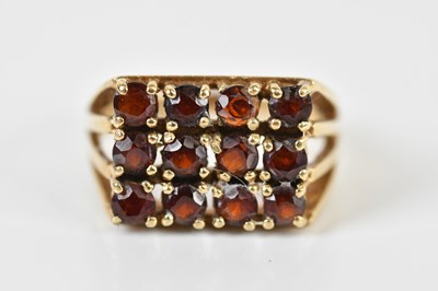 Lot 1483 - A 9ct yellow gold garnet platform set dress...