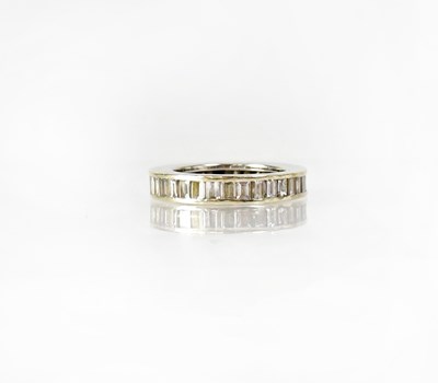 Lot 797 - A white metal eternity ring set with baguette...