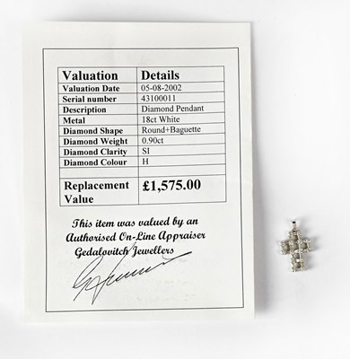 Lot 852 - An 18ct white gold cross pendant set with...