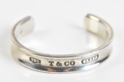 Lot 2081 - TIFFANY & CO 1837; a hallmarked silver bangle,...