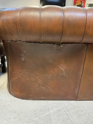 Lot 51 - A brown leather Chesterfield three-seater...
