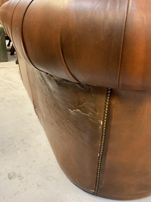 Lot 51 - A brown leather Chesterfield three-seater...