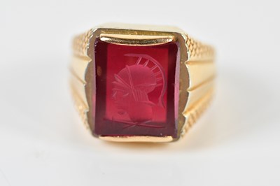 Lot 1362 - A yellow metal signet ring, with carved plaque...