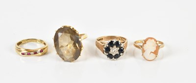 Lot 1407 - Four 9ct yellow gold dress rings including a...