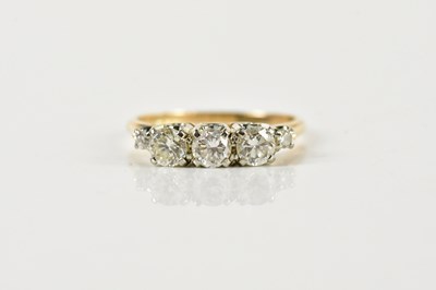 Lot 1322 - A yellow metal three stone diamond ring, each...