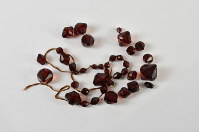 Lot 405 - A group of cherry amber coloured graduated...
