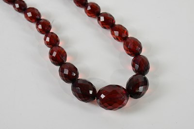 Lot 367 - A long cherry amber coloured facet cut...