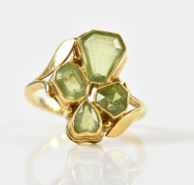 Lot 1409 - An 18ct yellow gold and green peridot ring of...