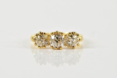 Lot 1274 - An Edwardian 18ct yellow gold three stone...