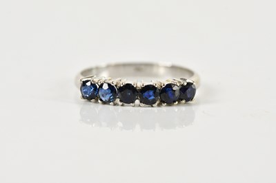Lot 1434 - A 14ct white gold six stone sapphire ring,...