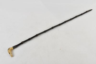 Lot 2592 - A late Victorian swagger stick, the carved...