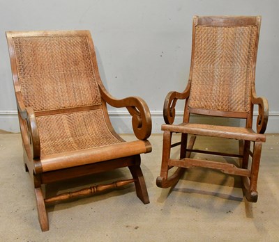 Lot 2462 - A large hardwood and rattan armchair with...