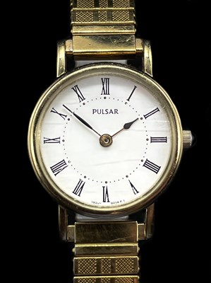 Lot 1347 - PULSAR; a lady's gold plated stainless steel...