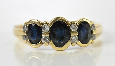 Lot 185 - A 9ct yellow gold dark sapphire and diamond...