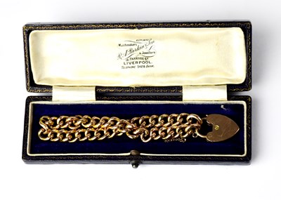 Lot 1110 - A 9ct yellow gold link bracelet with padlock...