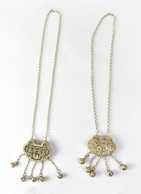 Lot 257 - Two Chinese white metal pierced infants'...
