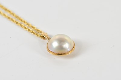 Lot 404 - A yellow gold and blister pearl pendant,...