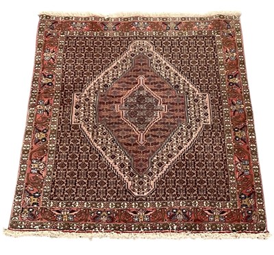 Lot 63 - A modern machine made red ground Persian style...