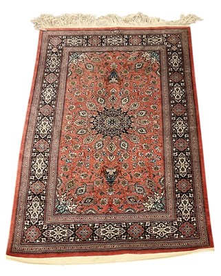 Lot 56 - An Isfahan red ground silk rug, with geometric...