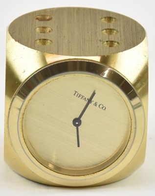 Lot 78 - TIFFANY & CO; a small brushed brass clock...