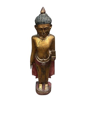 Lot 1333 - A decorative gilt and carved wood Buddha,...