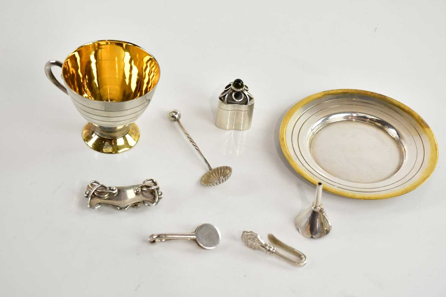 Lot 87 - A contemporary white and yellow metal cup and...
