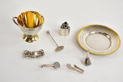Lot 87 - A contemporary white and yellow metal cup and...