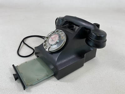 Lot 19 - A black Bakelite telephone with index drawer...
