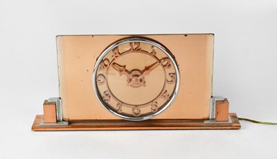 Lot 178 - An Art Deco peach glass mantel clock, the dial...