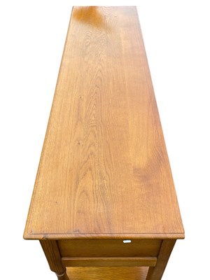 Lot 35 - A reproduction oak three drawer dresser base,...