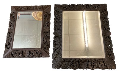 Lot 52 - An early 20th century wall mirror in heavily...