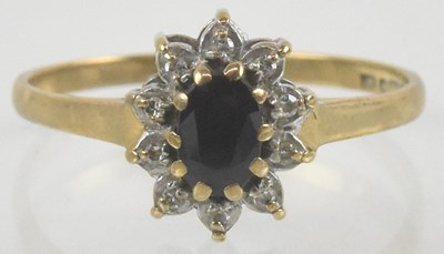 Lot 1185 - A 9ct gold sapphire and diamond ring, the oval...