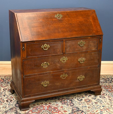 Lot 2718 - A George III oak bureau with fitted interior...