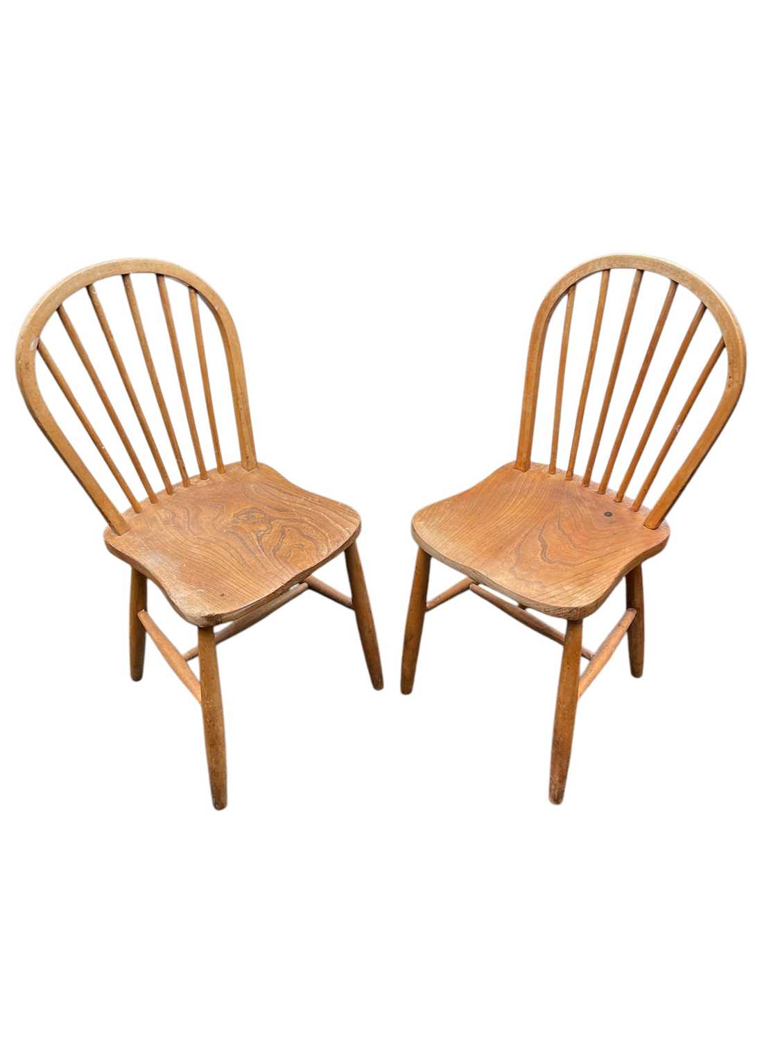 Lot 24 - ERCOL; a pair of stick back chairs.