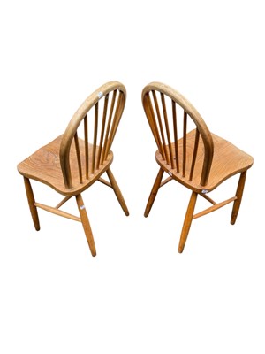 Lot 24 - ERCOL; a pair of stick back chairs.