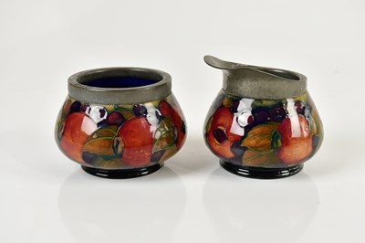 Lot 1417 - WILLIAM MOORCROFT; a milk jug and sugar bowl...