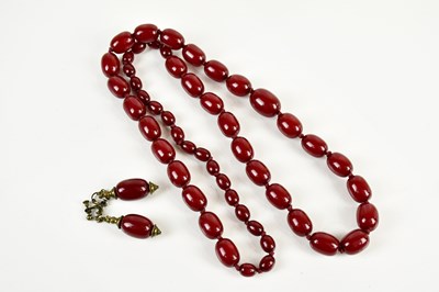 Lot 431 - A cherry amber coloured bead necklace, with...