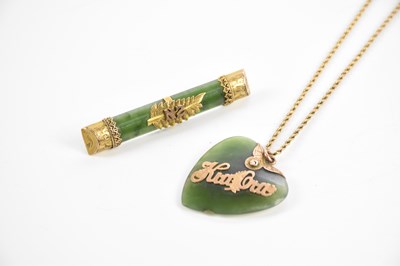 Lot 396 - A green hardstone heart shaped pendant...