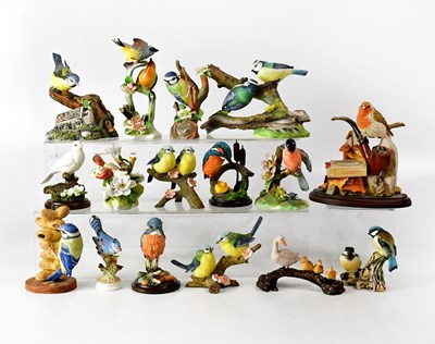 Lot 216 - Sixteen porcelain and resin figures of birds,...