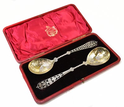 Lot 1099 - ELKINGTON & CO; a pair of pierced and parcel gilt silver servers