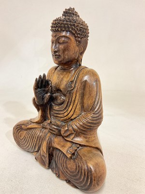 Lot 21 - A wooden seated Buddha, height 32cm.