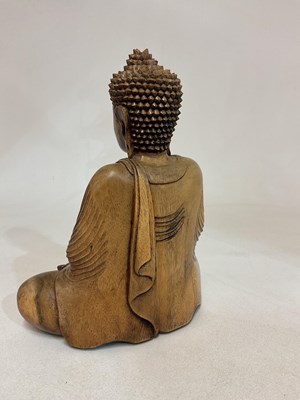 Lot 21 - A wooden seated Buddha, height 32cm.