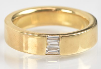 Lot 1238 - An 18ct yellow gold wedding band, set with...
